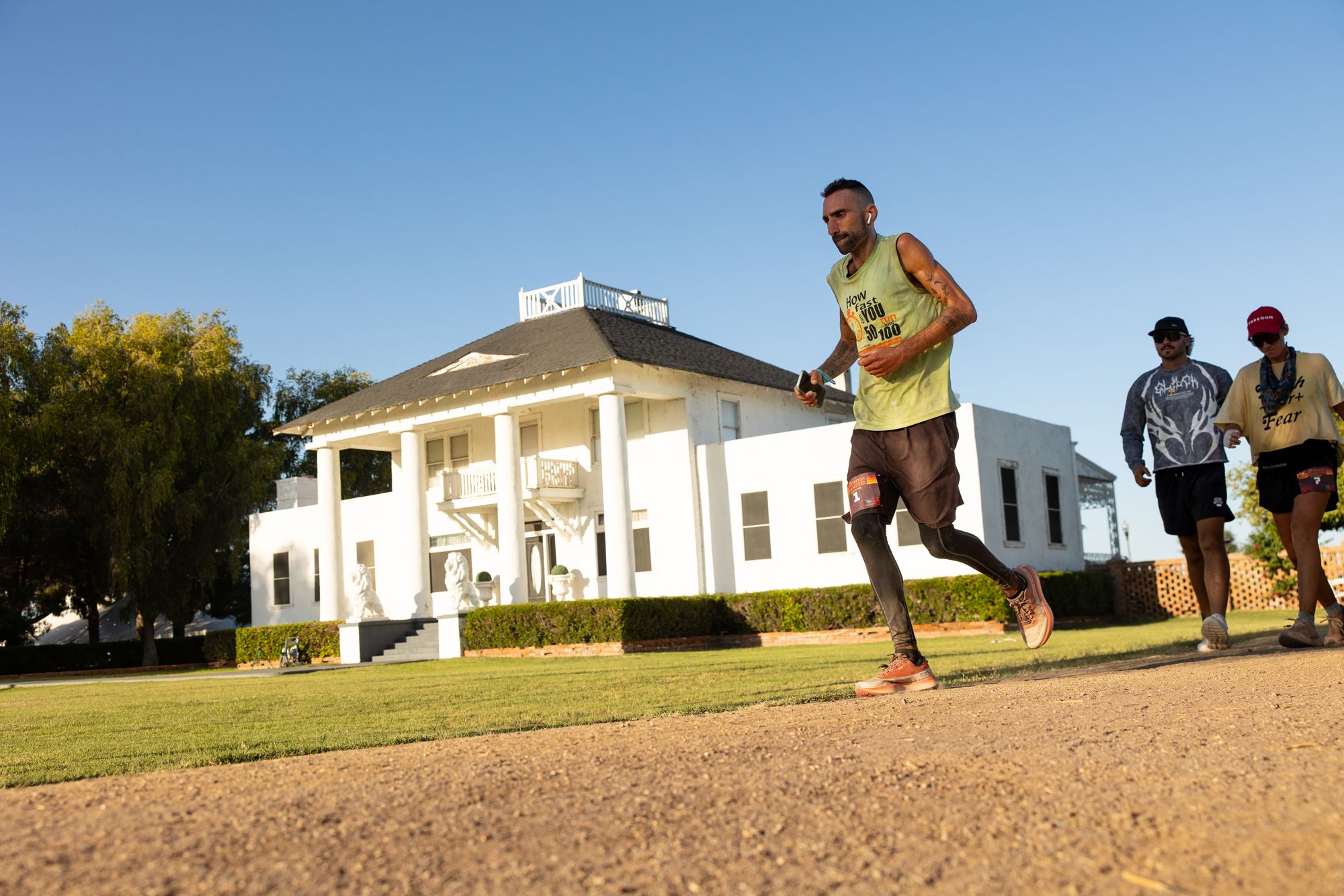Runner passing Nardini Manor on the loop