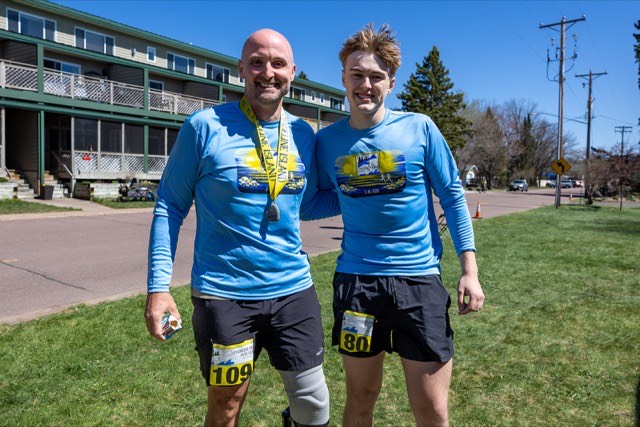 Two finishers with medals on the island